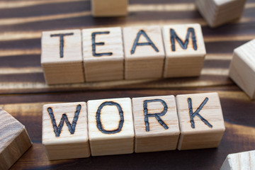 inscription team work wooden cubes with letters, wooden background