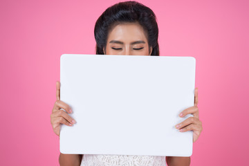 Portrait of fashion woman displaying white banner