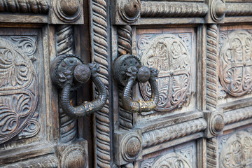 Beautiful old wooden door with iron ornaments in an Orthodox Church