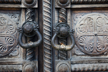 Beautiful old wooden door with iron ornaments in an Orthodox Church