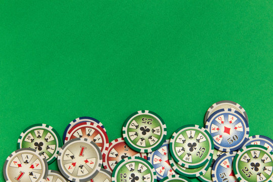 background with gambling  poker chips stack on green table. empty space for text and design