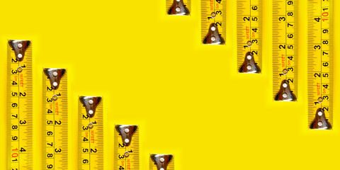 Yellow measurFrame yellow measuring tape on yellow background and texture.ing tape on yellow...