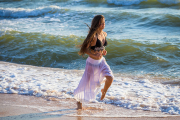 Beatiful girl running on the surf