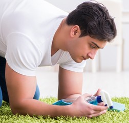 Young husband man cleaning floor at home