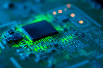 Electronic circuit board close up with green backlight