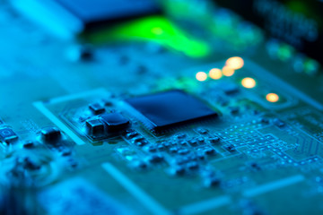 Electronic circuit board close up with green backlight and a light haze