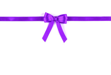 Shiny purple silk ribbon on white background.