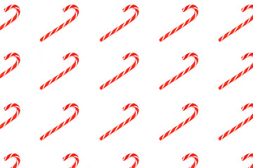 Pattern made from Christmas candy canes isolated on white.