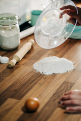 making homemade pizza dough on wooden countertop with wholemeal flour