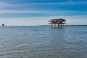 Traditional Thai fisherman houses made of wood in the middle of the sea