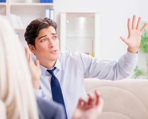 Young man visiting psychiatrist doctor for consultation