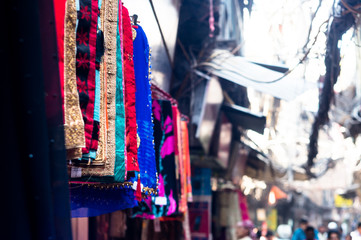 Fototapeta na wymiar Beautiful handicraft scarves and shawls hanging on a street side shop for sale
