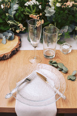 Festive table setting. The decor of the tree. Cutlery and fresh greens.