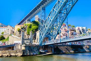 Obraz premium Famous steel bridge dom Luis above connects Old town Porto with Vila Nova de Gaia at river Douro, Portugal.