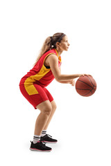 Young woman in a sports jersey playing basketball