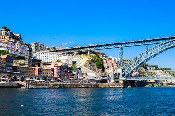 Fototapeta na wymiar Famous steel bridge dom Luis above connects Old town Porto with Vila Nova de Gaia at river Douro, Portugal.