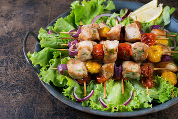 Chicken kebabs on skewers with tomatoes and onions. Hot kebabs for dinner. Summer diet.