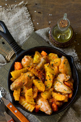 Chicken stew with caramelized pear on rustic wooden table.