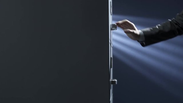 Businessman trying to open a locked drawer in the archive