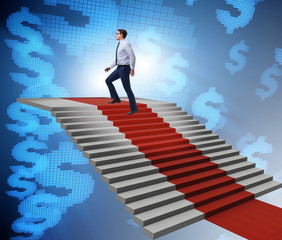 Young businessman climbing stairs and red carpet