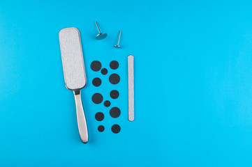 Top view of manicure and pedicure equipment on blue background