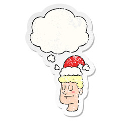 cartoon man wearing christmas hat and thought bubble as a distressed worn sticker