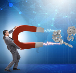 Businessman catching dollars on horseshoe magnet