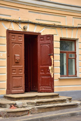 old ruined porch with brown wooden door