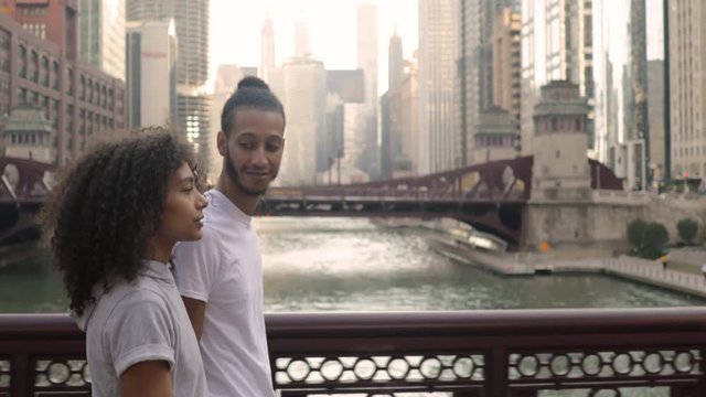 Cute African American couple walk together in Chicago after their morning workout.