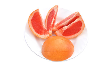 slices of grapefruit on plate isolated on white