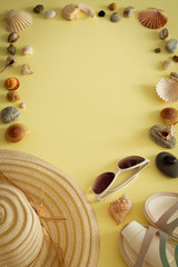 a holiday photo a summet hat, beach sandals,sunscreen,sun glasses, scallops and souvenir pebbles. Empty space for an inscription