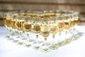 transparent champagne glasses on a white table