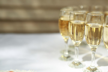 transparent champagne glasses on a white table
