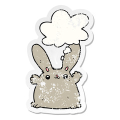 cartoon rabbit and thought bubble as a distressed worn sticker