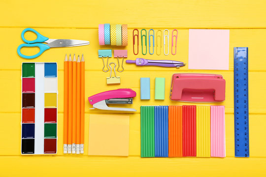 School supplies on yellow wooden table