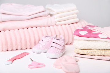 Obraz na płótnie Canvas Clothes with baby supplies on white background