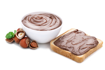 Melted chocolate with hazelnuts and bread isolated on white background