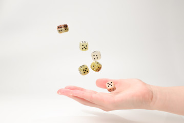 Woman throws dices isolated on white.