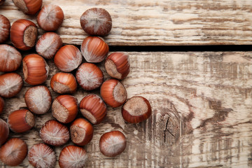 Ripe hazelnuts on brown wooden table