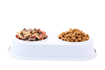 Dry pet food in bowls isolated on white background