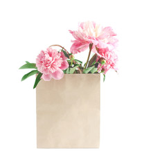 flower concept. eco paper bag and a bouquet of pink peonies. layout with space for text