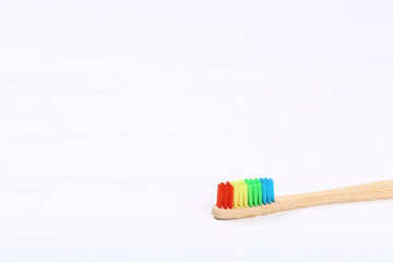 Bamboo toothbrush on white wooden table