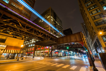 An L train runs over West Monroe Street and South Wabash Avenue.