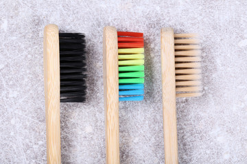 Bamboo toothbrushes on grey background