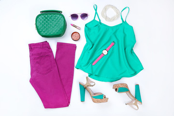 Stylish women's clothes with sunglasses and accessories on white background