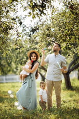 Happy family in the green garden at summer