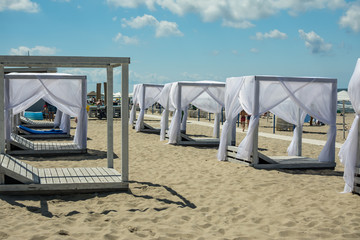 wooden sunshades on the beach comfortable loungers