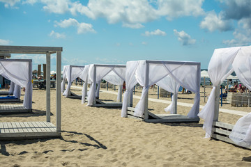wooden sunshades on the beach comfortable loungers