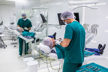 Senior man having dental treatment at dentist's office.