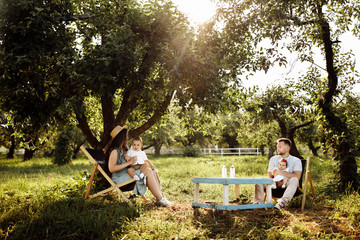 Happy family in the green garden at summer